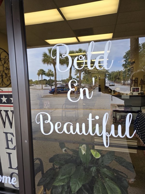 Bold En' Beautiful script lettering on the salon's front window